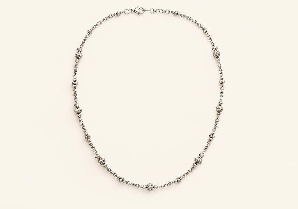 Silver chain on an ivory studio background after Yuvexa enhancement